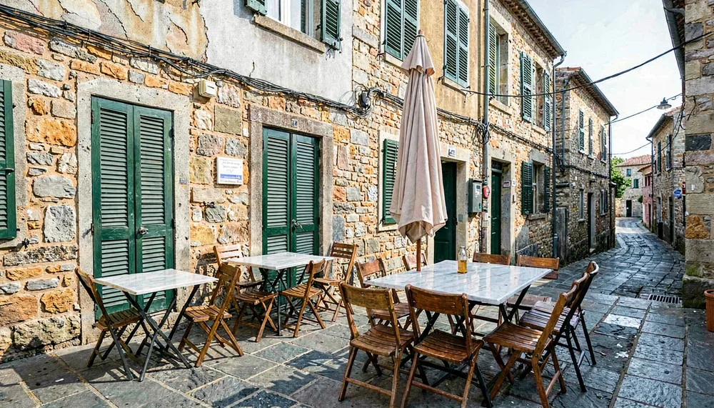 Empty restaurant terrace with folded parasol in an old town street before opening